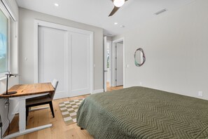 A bedroom with a bed, a desk, and a chair. - Paradise Grove 3 Bedroom Home (Sarasota)