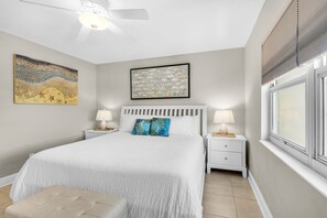A bedroom with a bed, two nightstands, a ceiling fan, and artwork on the walls. - 🐾 Regency Towers 808W | Pet Friendly Gulf Front | 3BR + Snorkeling Reefs (Pensacola Beach)