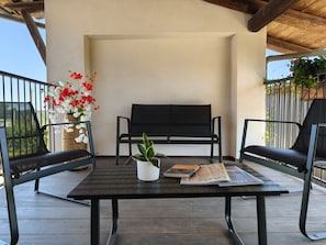 An outdoor seating area with a table, two chairs, a bench, and a potted plant. - Studio at Agriturismo al Campo del Nocciolo in the countryside with Maira Valley view (Busca)