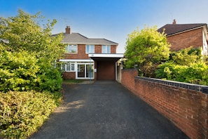 A residential property with a paved driveway leading to a garage. - Bhllys (Wolverhampton)