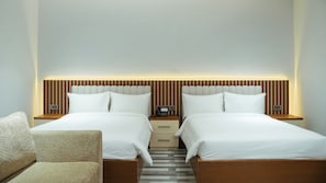 A hotel room with two beds, a wooden headboard, bedside tables, a phone, and a chair. - The Urban Stay Kalumbila (Kalumbila)