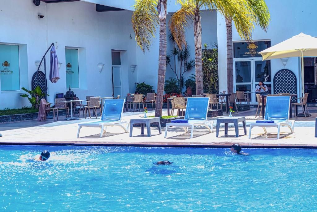 A poolside area with lounge chairs and a restaurant.