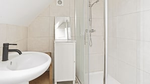 A bathroom with a white sink, a mirror, a shower enclosure, and a toilet. - Heritage Room - (Egham Station 1 min walk) (Egham)