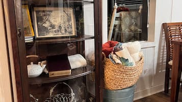 A wooden cabinet with glass doors containing various items.