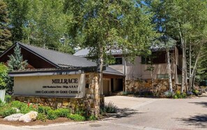 A building with a stone foundation and a metal roof, labeled 'MILLRACE 1890 CASCADES ON GORE CREEK.' - New Listing! Ski-In Ski-Out Penthouse | Community Hot Tub, Sauna & Pool (Vail)