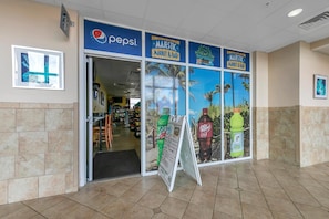A store entrance with Pepsi branding, a market & bar, and a Paradise Pizza sign. - 17th Floor Gulf Escape | Sleeps 6 | Pools, Hot Tubs & More (Panama City Beach)