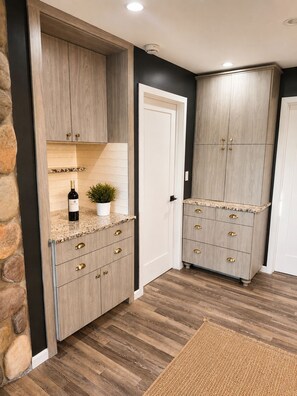 A kitchen with wooden cabinets, a countertop, and a potted plant.