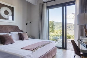 Une chambre avec un grand lit, un bureau et une vue sur l’extérieur.