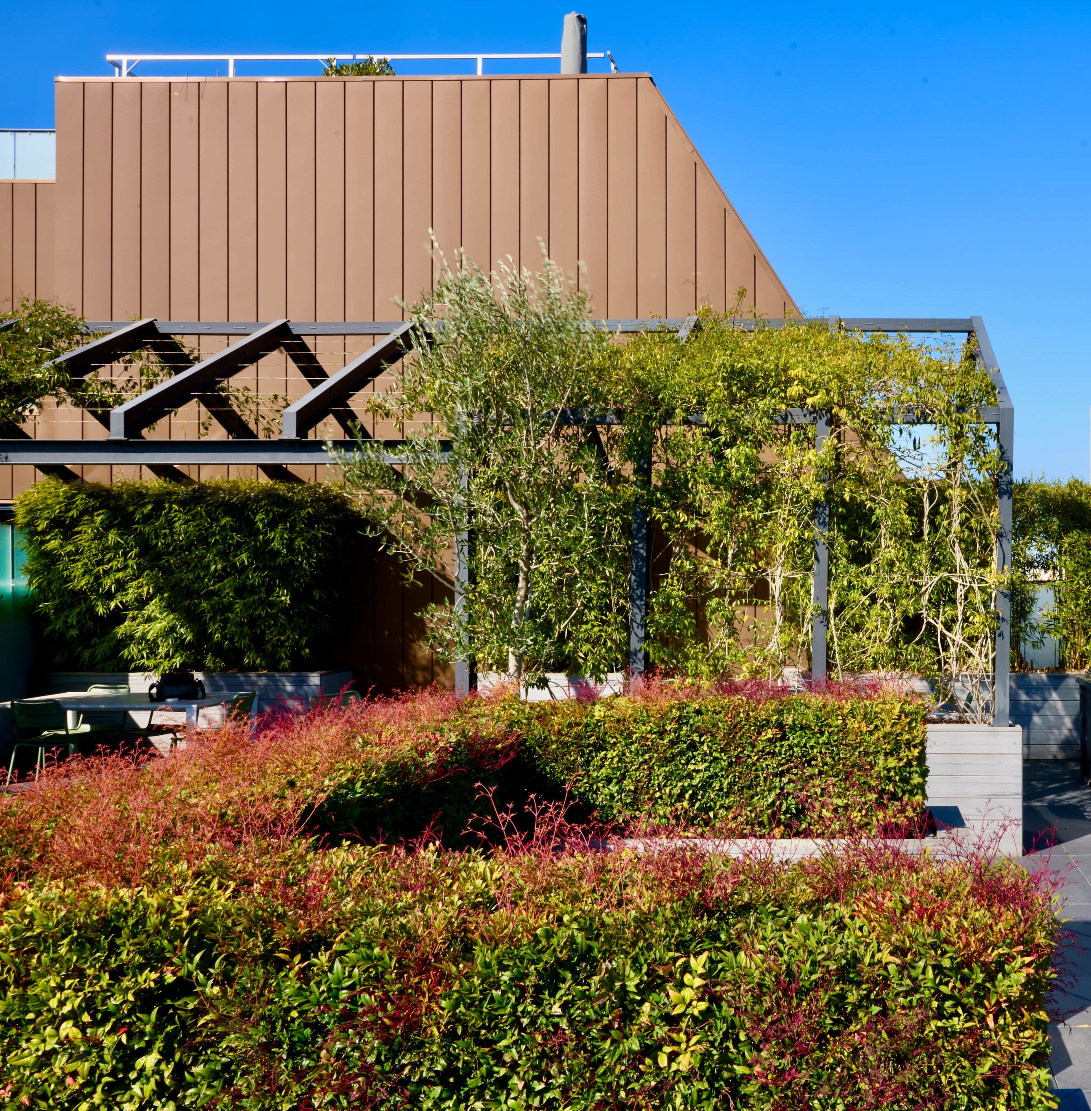 A modern building with a sloped roof and a metal staircase leading to an upper level.
