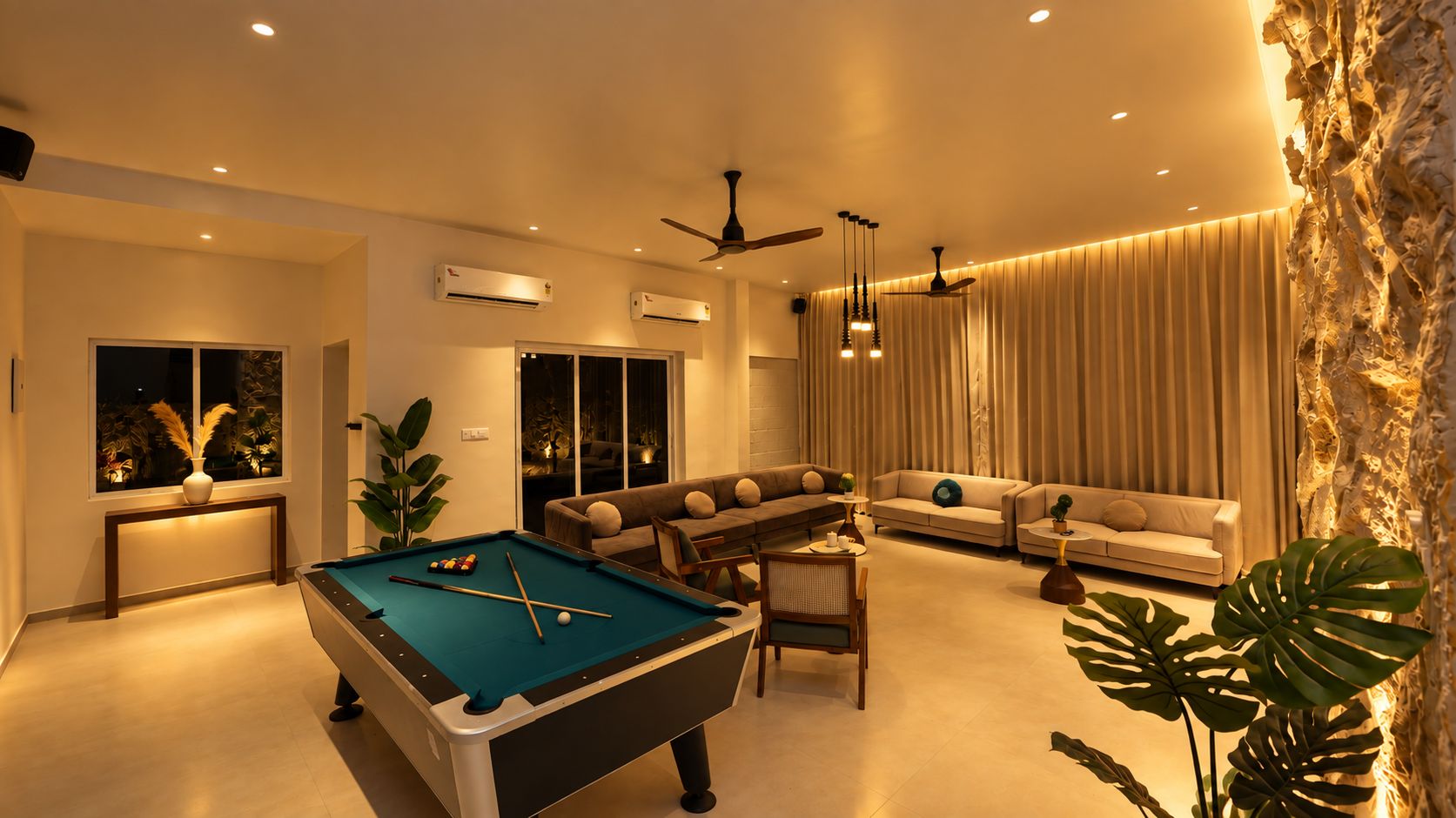 A modern living room with a pool table, sofas, and a dining area.