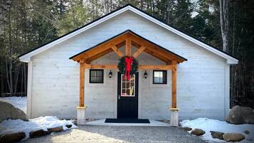A small, single-story building with a gabled roof and a front porch.