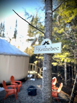 A sign with the name 'The Kennebec' attached to a tree.