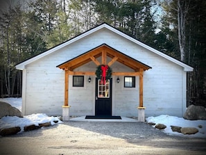 A small, single-story building with a gabled roof and a front porch.