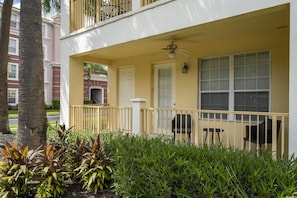 A two-story building with a balcony, a door, and a window. - Vista Cay near Epic Apartment remodeled (Orlando)