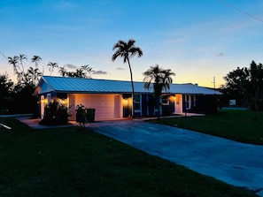 A single-story house with a garage, a covered porch, and a driveway. - Your Private Florida Escape - Stunning Pool Home (Fort Myers Beach)