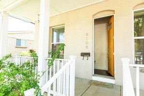 A residential building with a white exterior, a mailbox, and a door with the number 4108. - Trendy 1BR w/Office & Wellness Rm l Sunnyside (Denver)