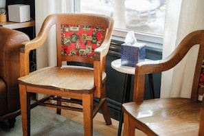 A wooden chair with a patterned cushion, a tissue box, and a small table with a tissue box. - Boutique 1BD Townhome w/Great Patio in Wash Park (Denver)