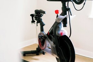 A stationary exercise bike with a control panel and a red button. - Home Away from Home w/Sauna 4BD|2BA | Berkley (Denver)