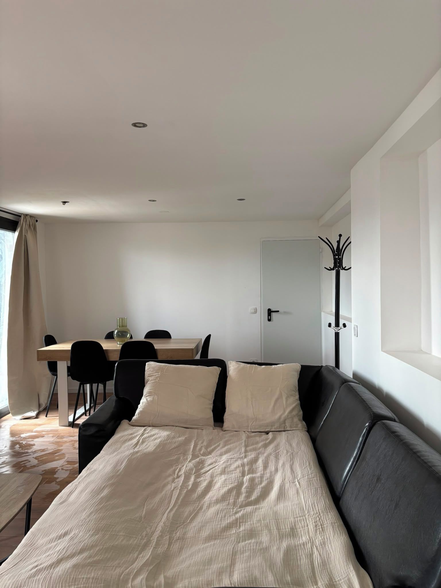 A modern room with a bed, a desk, and a chair.