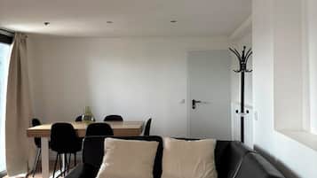 A modern room with a bed, a desk, and a chair.