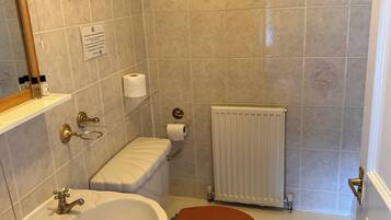 A bathroom with a sink, toilet, and bathtub.