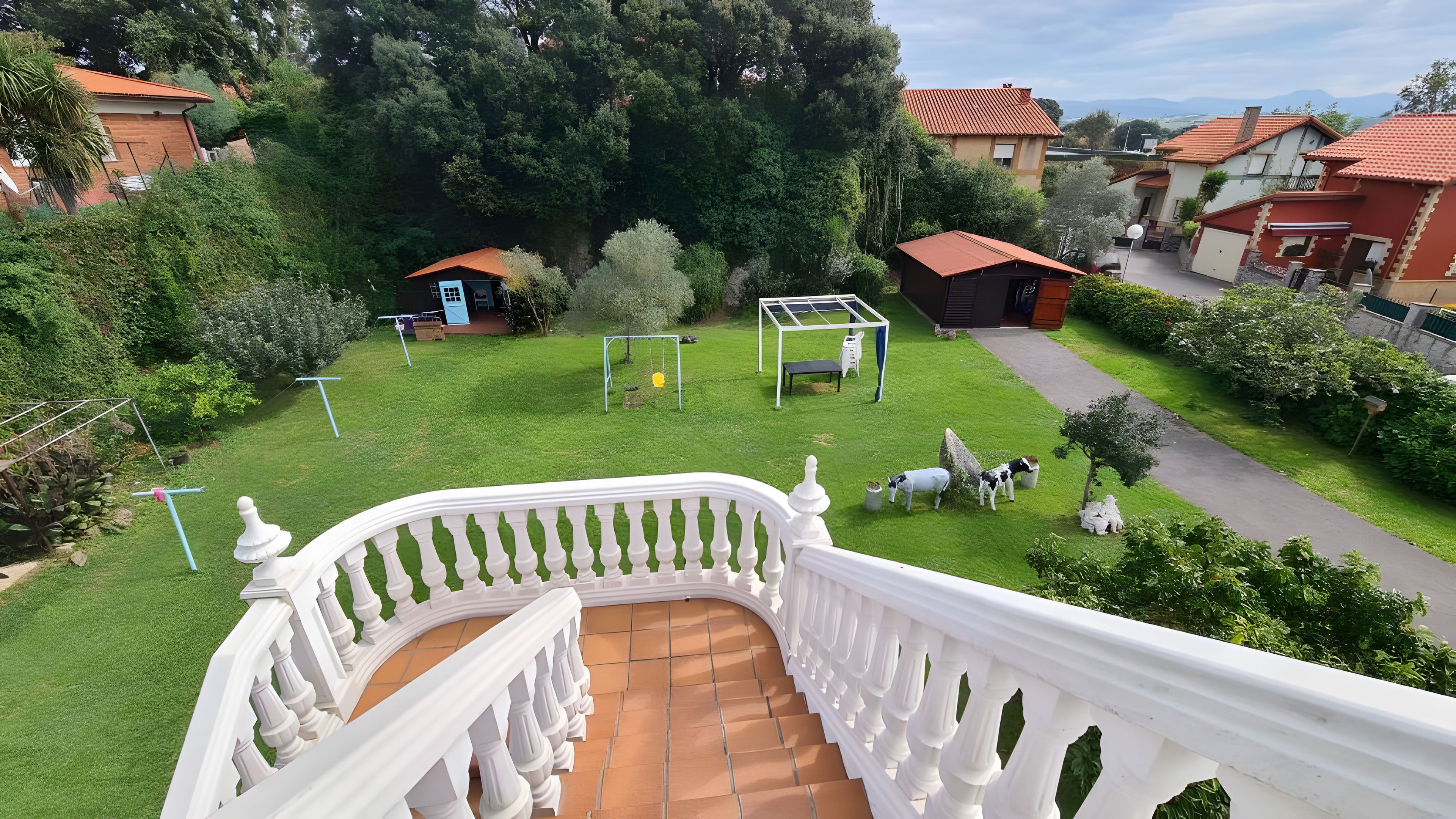 A residential area with a well-maintained lawn, a swing set, and a gazebo.