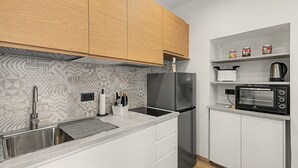 A compact kitchen with a stainless steel refrigerator, a built-in oven, a microwave, and a sink with a modern faucet. - Apartment 'Mimi' with Balcony, Wi-Fi and Air Conditioning (Taggia)