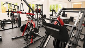 A gym with various exercise equipment, including a squat rack, bench press, and weight plates. - Sunbay- Breakfast, hotel, WiFi, Beach Access (Bridgetown)