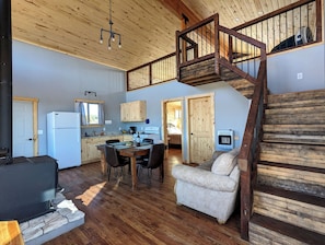 A spacious kitchen with a dining area, a staircase, and a cozy seating area. - Remote 2 bedrooms cabin (La Sal)