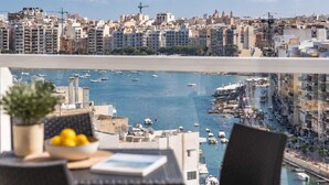 A balcony with a view of a marina and cityscape. - Sea Views & Terrace - 2BR Penthouse, St Julian's (San Ġiljan)