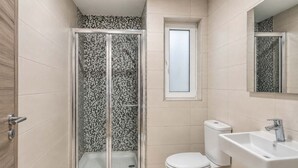 A bathroom with a shower enclosure, toilet, and sink. - Sea Views & Terrace - 2BR Penthouse, St Julian's (San Ġiljan)