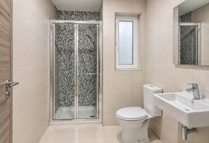 A bathroom with a shower enclosure, toilet, and sink. - Sea Views & Terrace - 2BR Penthouse, St Julian's (San Ġiljan)