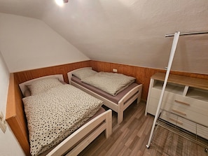 A small, compact room with two wooden bunk beds, a white ceiling, and a wooden floor. - Holiday Home Kretscham with Private Terrace and Garden (Sehmatal)