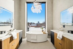 A modern bathroom with a central round sink, two mirrors, and a view of a cityscape through a large window. - Luxury Toronto Home with Rooftop Terrace & Parking (Toronto)