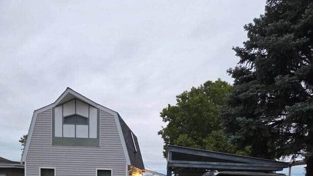 A residential house with a garage and a parked SUV. - The Nelson 2, Winner (Winner)