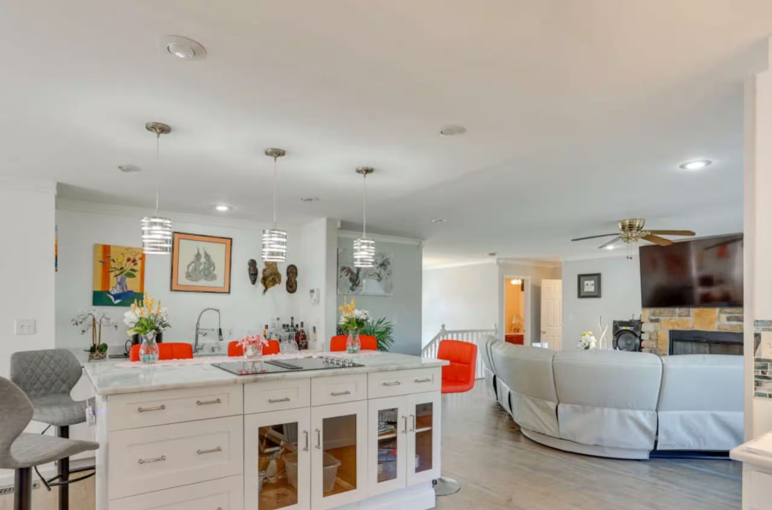 An open kitchen with a central island opens directly into the adjacent living room.