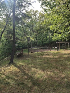 A park with a wooden bench, a birdhouse, and a fenced area. - Meeting Waters~The Crows Nest (Tatamagouche)