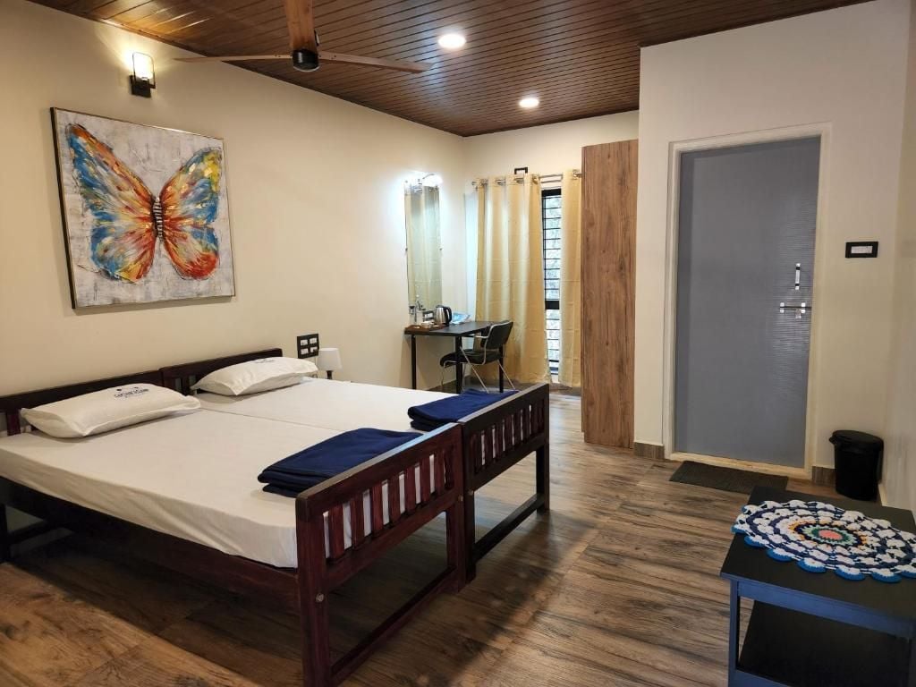 A bedroom with a bed, a desk, and a chair.