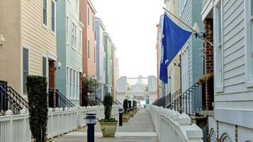 A row of colorful townhouses with a wooden boardwalk between them.
