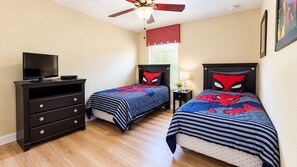 A bedroom with two beds, a TV stand, a ceiling fan, and a window with blinds. - 6BR Family Vacation Home Paradise Palms Private Pool Near Disney (Kissimmee)