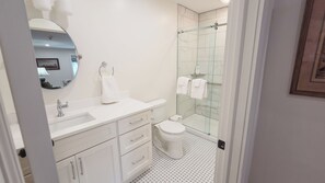 A modern bathroom with a white sink, mirror, and toilet. - Spacious 2 bedroom apartment located minutes from Ithaca, Cornell, Cortland (Groton)