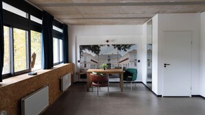 A modern interior with a large window, a wooden table, and a green chair. - Large Room in Rijswijk (Rijswijk)