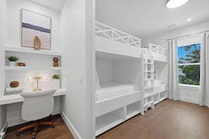 A room with bunk beds, a desk with a chair, a bookshelf, and a window with curtains. - Golf Cart, Large Pool, Hot Tub, Walk 2 Beach, Bikes (Santa Rosa Beach)