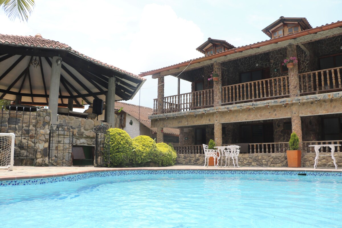 A swimming pool with a stone facade building in the background.