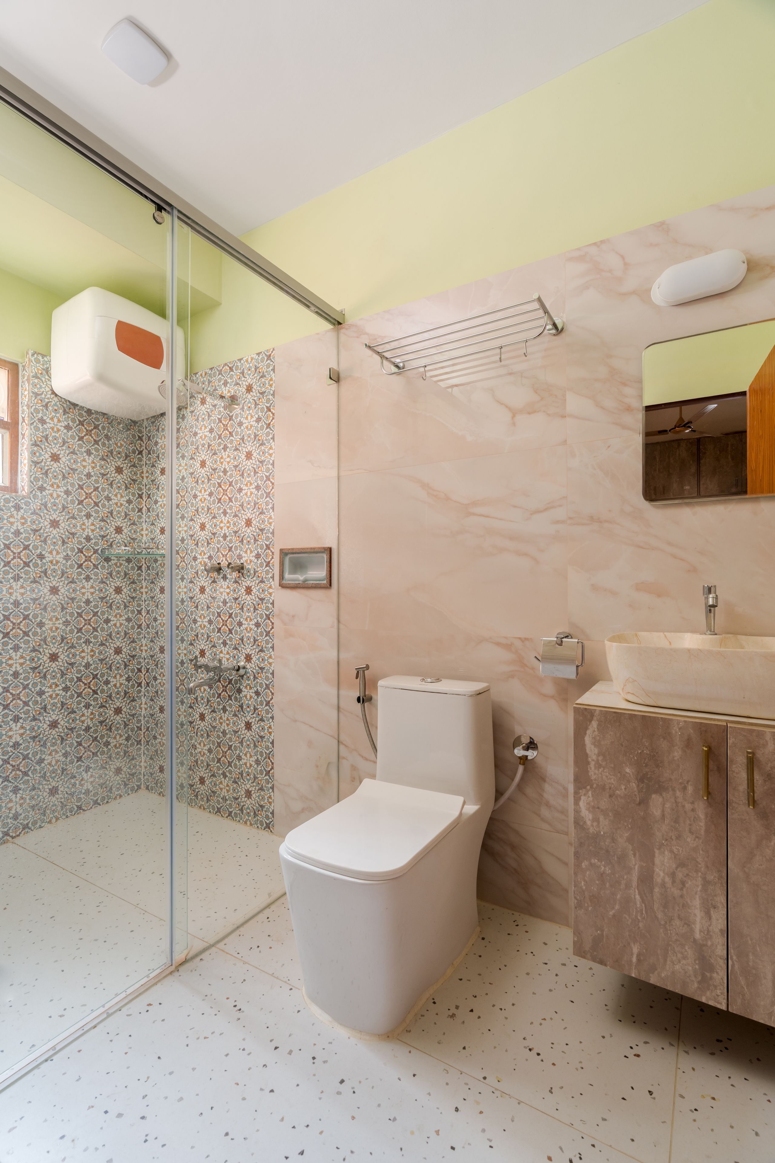 A modern bathroom with a toilet, sink, and shower.