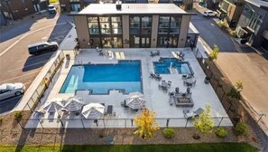 A swimming pool area with multiple pools and lounge chairs. - Entire Home in Whitefish, Montana (Whitefish)