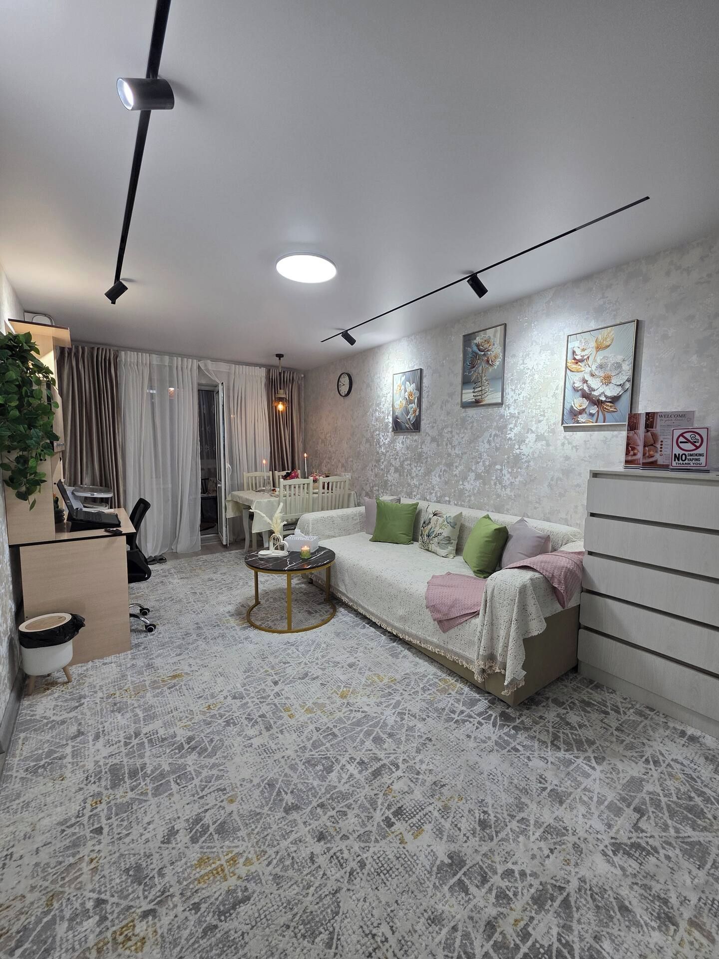 Un salon moderne comprenant un canapé, une table basse et un coin repas avec une table et des chaises.