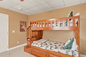 A bunk bed with a wooden frame, a lower drawer, and a headboard with vertical slats. - Cedar Sunset - Big Views, Two Fireplaces, 4BR on Beech Mountain (Beech Mountain)