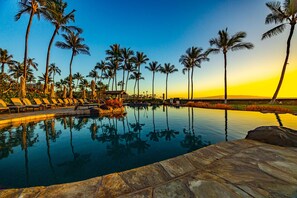 A pool with lounge chairs and palm trees. - Wailea Beach | 3 Oceanfront Villas, Sleeps 20 | Car Incl. w/ 6+ Nights | ML-4271 by KBM (Wailea)