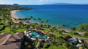 A resort with a pool, palm trees, and a beach. - Wailea Beach | 2 Oceanfront Villas, Sleeps 14 | Car Incl. w/ 6+ Nights | ML-4274 by KBM (Wailea)